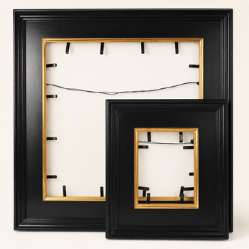 Two Casina 10 frames in different formats, frontal view without artworks — spring clips for artwork retention and hanging cord visible through the frame opening from the back, gilt lip inside