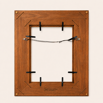 Back of a handcrafted picture frame — spline-joined mitres, spring clips, cord between D-rings, workshop signature