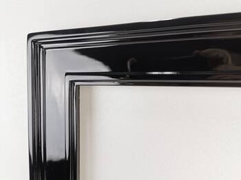 Corner of a wooden mirror frame lacquered in black high gloss, made to measure