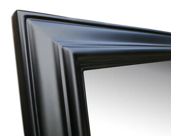 Corner of black wooden mirror frame — dowel joints, classic multi-step moulding profile, semi-matte lacquer finish
