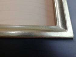 Mirror in black frame, partially gilded white gold leaf