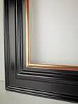 Detail of corner join on handcrafted gold picture frame showing perfect alignment.