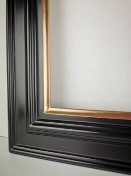 Detail of corner join on handcrafted gold picture frame showing perfect alignment.