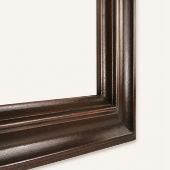 Corner of a hand-painted dark wood frame – mitred and splined join, cove profile and red revealed along the edges.