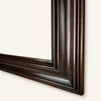 Close-up of the frame finish – dark brown with red glowing through, hand-patinated, with the satin sheen of a waxed surface.