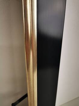 Black picture frame, partially gilded white gold leaf over red bole.