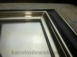 Mirror in black frame gilded with white gold leaf