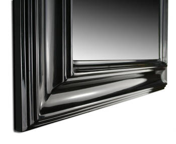 Close-up of black glamour mirror frame corner — solid wood, high gloss lacquer