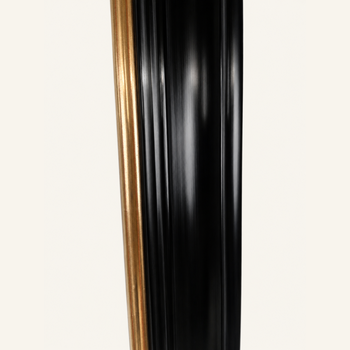 Side profile of a black and gold gilded picture frame: satin-sheen black and a gilded inner frame over red bole.