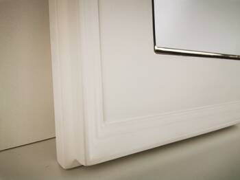 Macro view of the picture frame corner revealing the smooth painted surface and refined gold finish. 