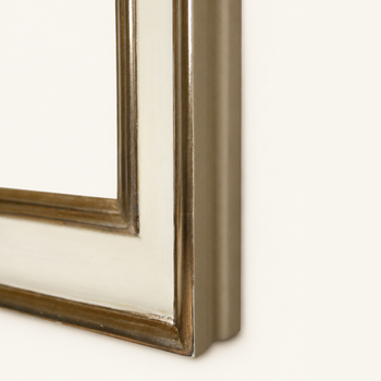 Mitred corner of the cream and gold frame joined with a wooden spline, with gilded edge